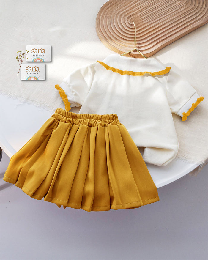 Children's outfit with white shirt and yellow skirt on a white background