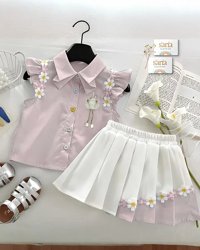 Young girl in a light purple shirt and white skirt with floral patterns, holding a white bag.