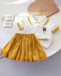Children's outfit with white shirt and yellow skirt on a white background